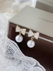 white bow earrings